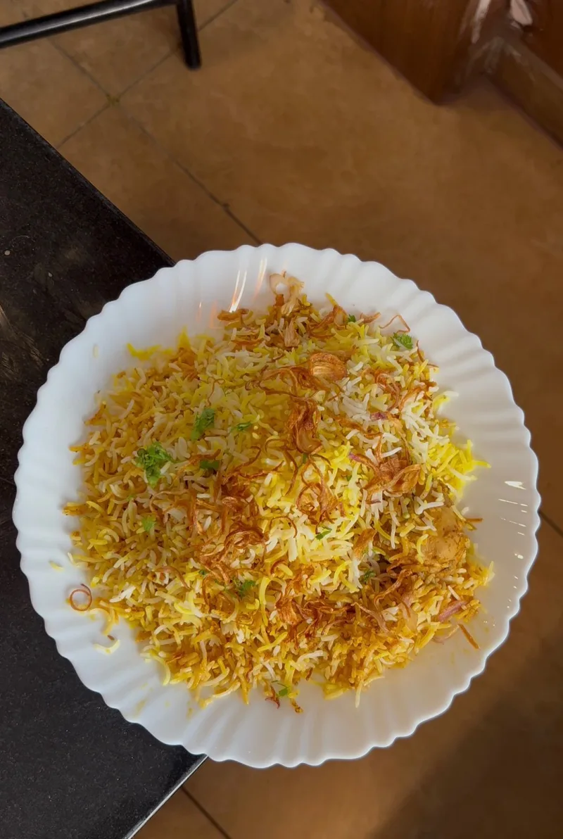 A plate of biryani, shot on a phone